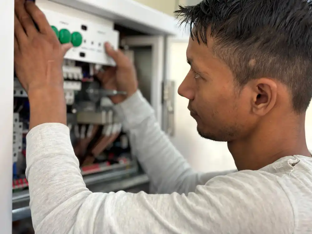 Sample photo: an electrician working in an open electrical panel