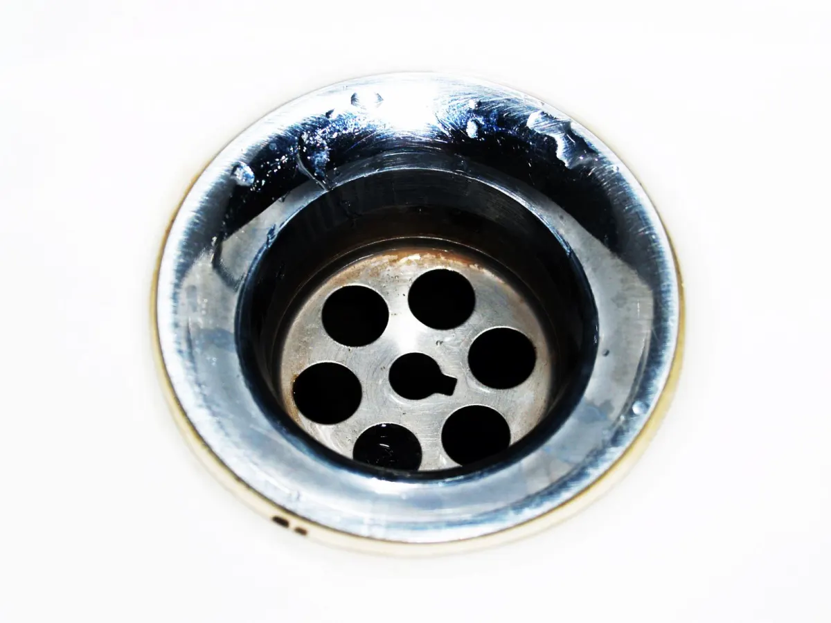 A chrome sink drain, close up