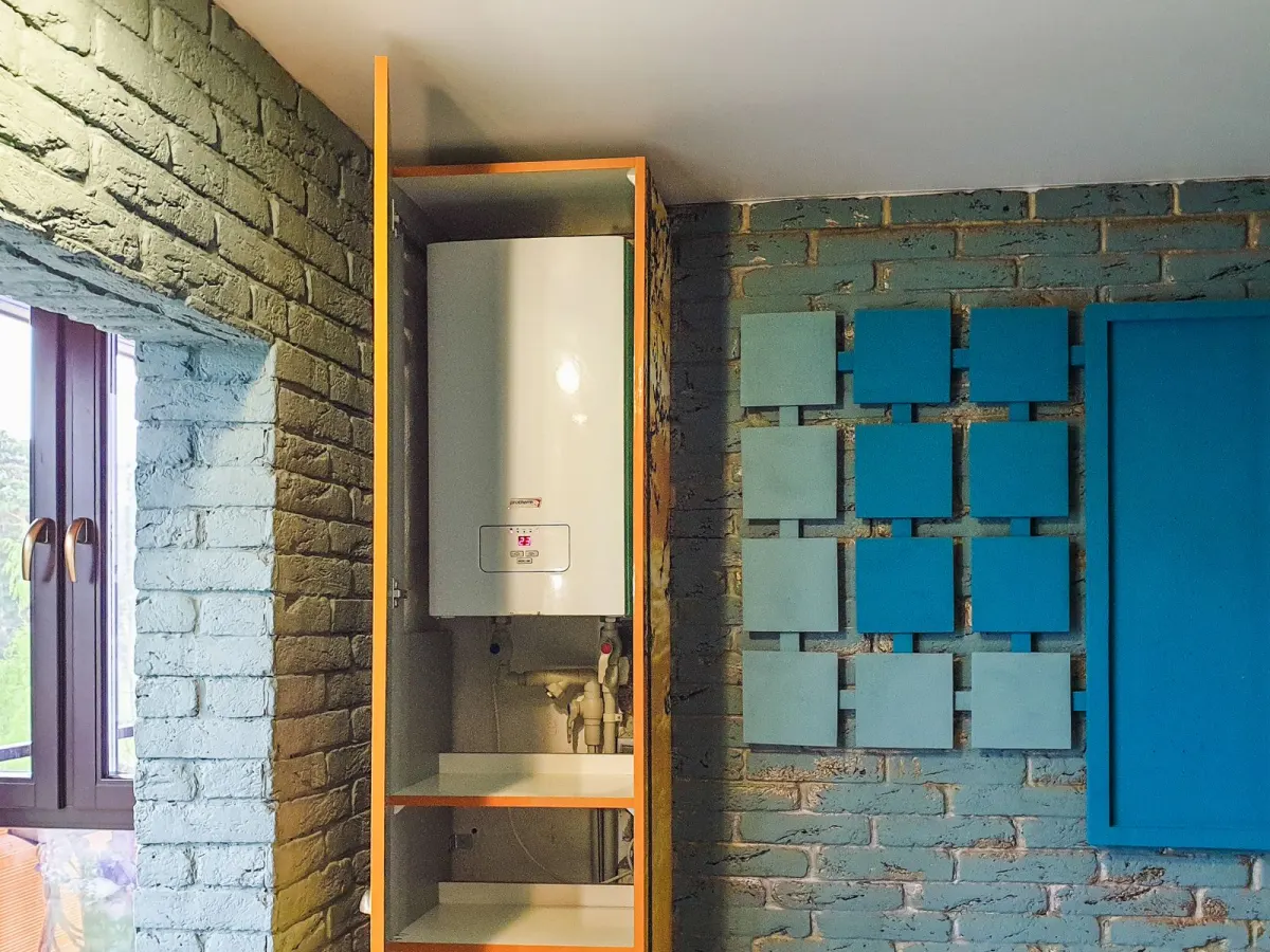 A wall-mounted water heater in a bathroom cabinet